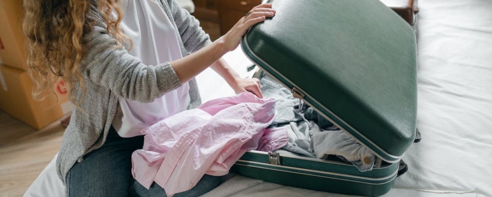 A woman packing her suitcase. 