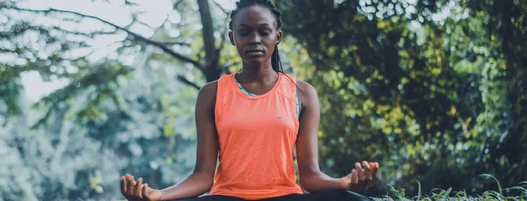 woman meditating in nature before trying yoga and sound therapy