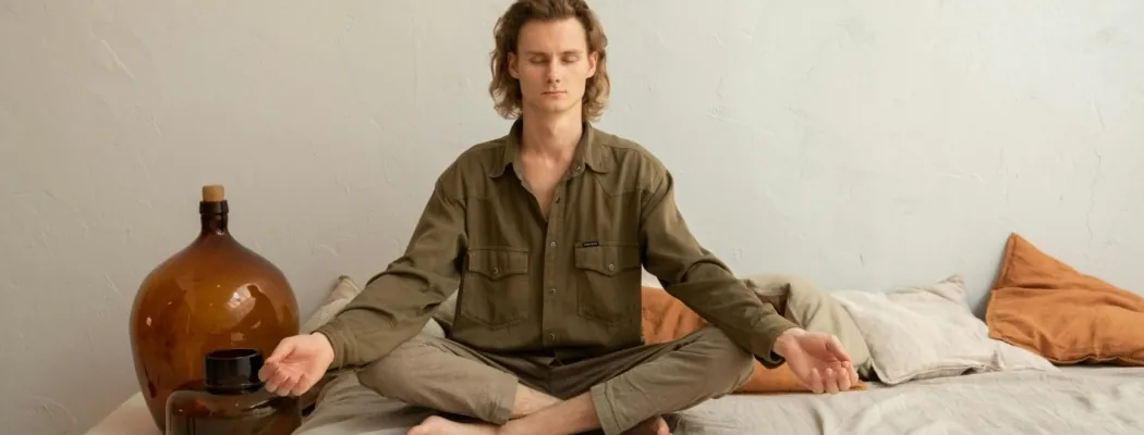A man meditating trying to avoid symptoms of withdrawal from weed