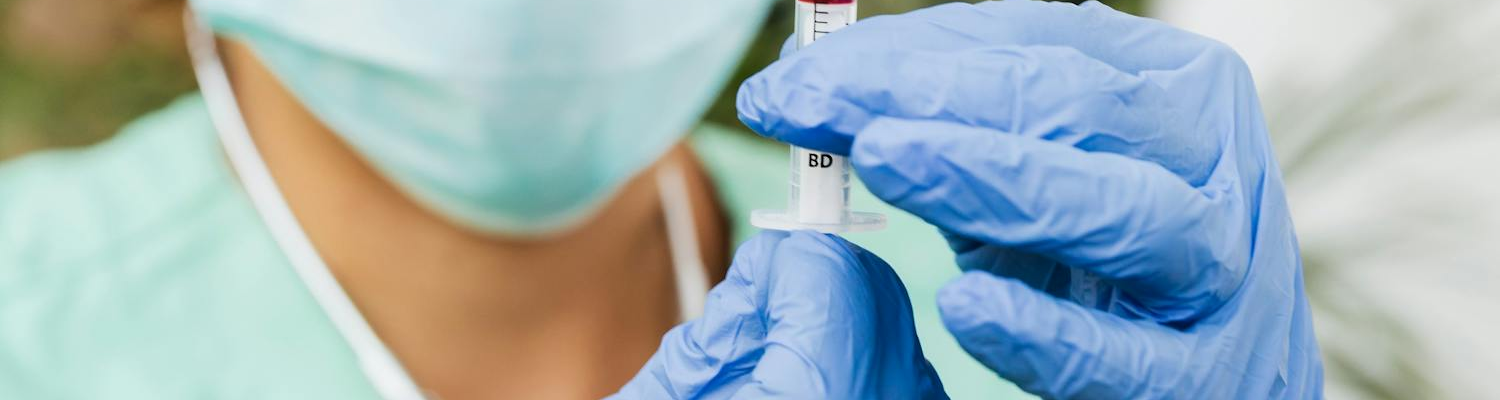 A nurse preparing a syringe.
