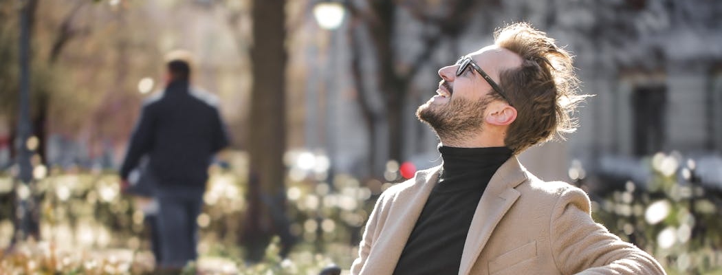 A person looking at the sky, feeling optimistic and happy