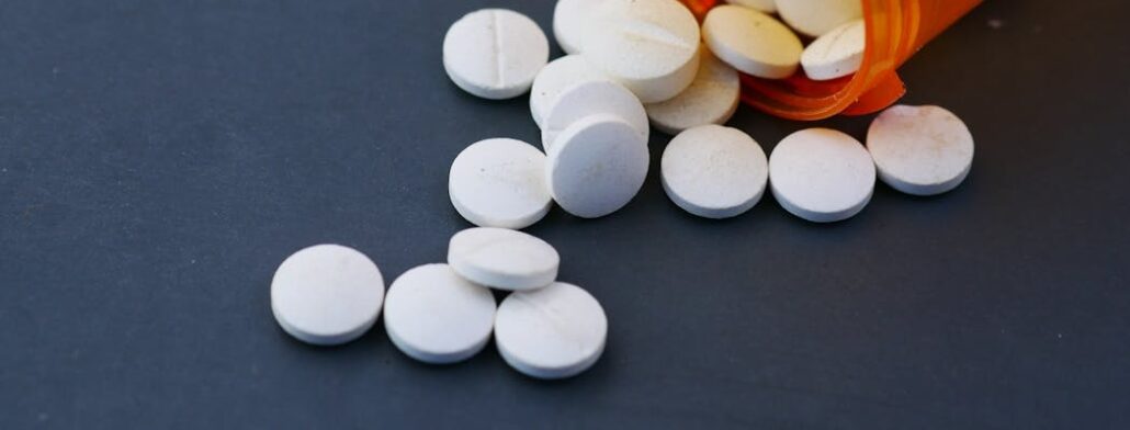 Methadone pills on a blue surface