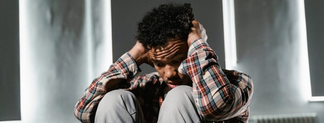 An anxious person holding their head