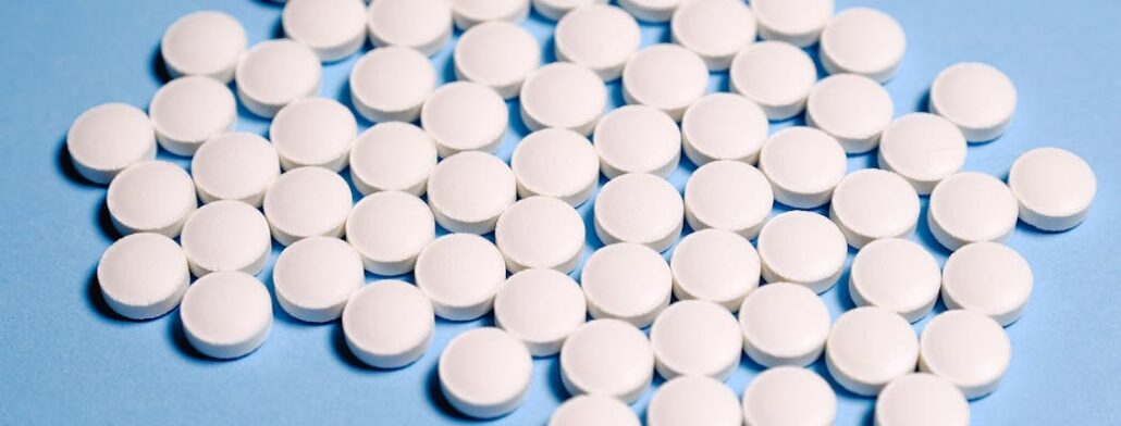 White pills on a blue surface